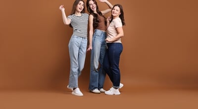 Portrait,Of,Three,Happy,Friends,On,Brown,Background