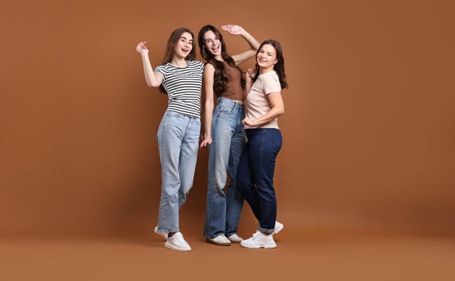 Portrait,Of,Three,Happy,Friends,On,Brown,Background