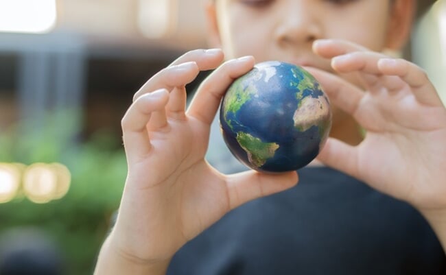 Selective,Focus,Of,Child,Holding,Small,Earth,Globe,Outdoor.,Concept