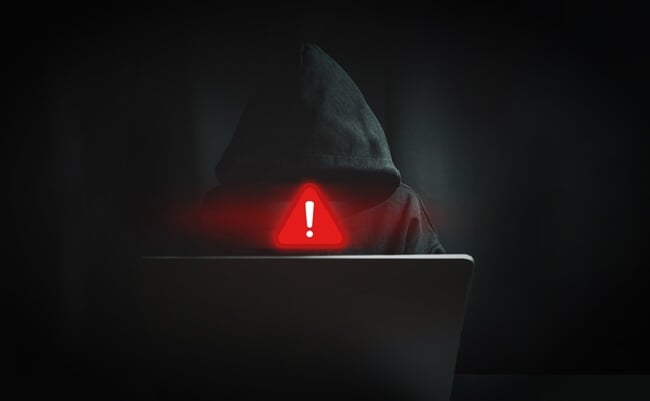 Cyber,Security,Threat,Concept,With,Anonymous,Hacker,Behind,Laptop,And