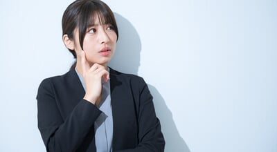 Young,Japanese,Woman,In,Suit,With,Hand,On,Chin,Thinking