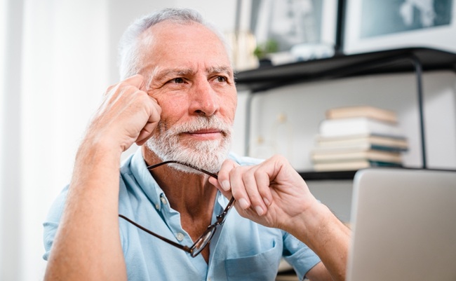 Tired,Mature,60s,Man,Working,At,Laptop,From,Home,,Taking