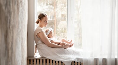 Mom,And,Baby,,Mother,Gently,Hugs,Her,Baby,Sitting,At