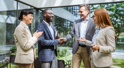 Happy,Black,Businessman,And,Caucasian,Businessman,Shaking,Hands,At,Meeting