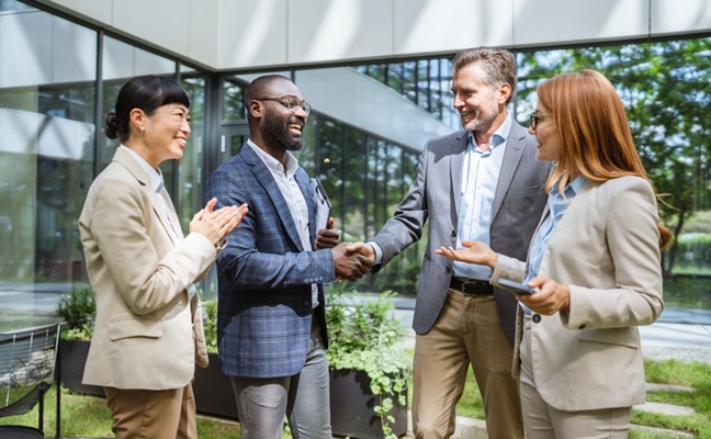 Happy,Black,Businessman,And,Caucasian,Businessman,Shaking,Hands,At,Meeting