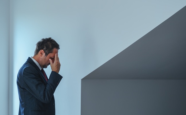Stressed,Businessman,Touching,His,Forehead,,Symbolic,Of,Burnout,,Pressure,,And