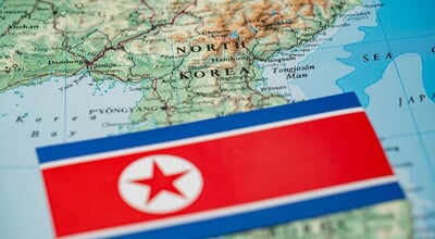Close,Up,Of,North,Korea,Flag,On,Map,Of,North